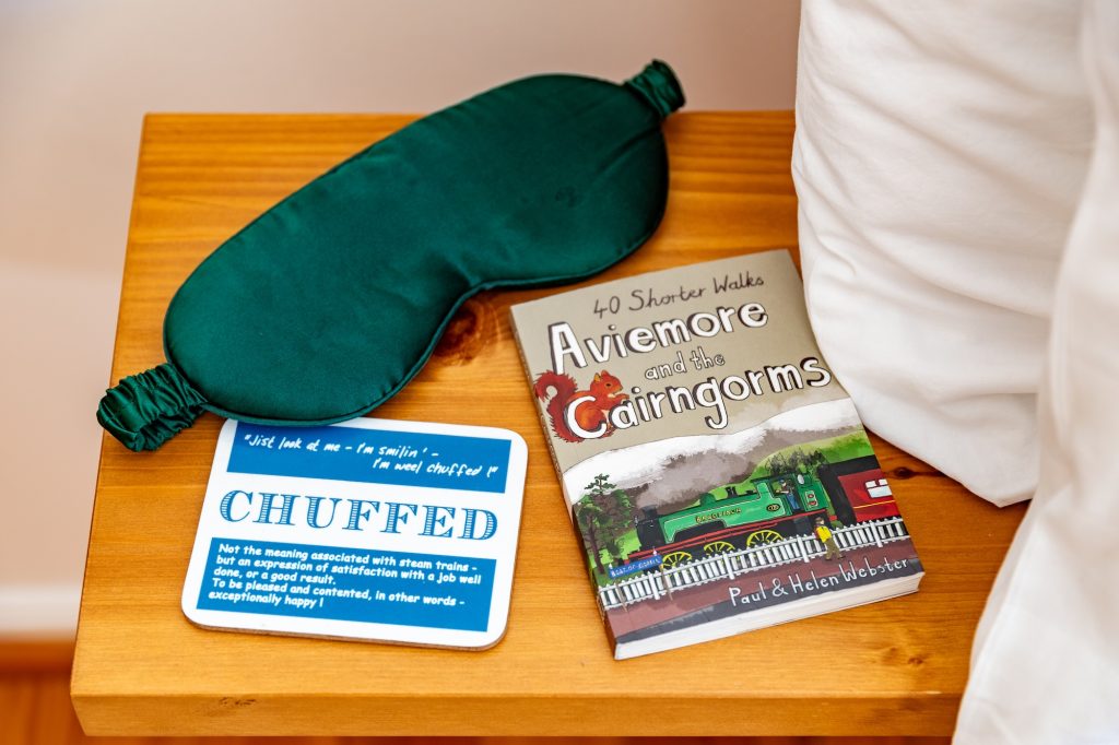 Bedside table with eye mask, Glencoldon welcome card, and local activity guide