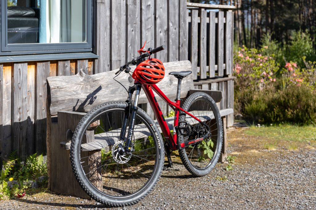 Mountain bikes with helmets parked outside self-catering Glencoldon Cottage, ready for a local Cairngorms cycling adventure